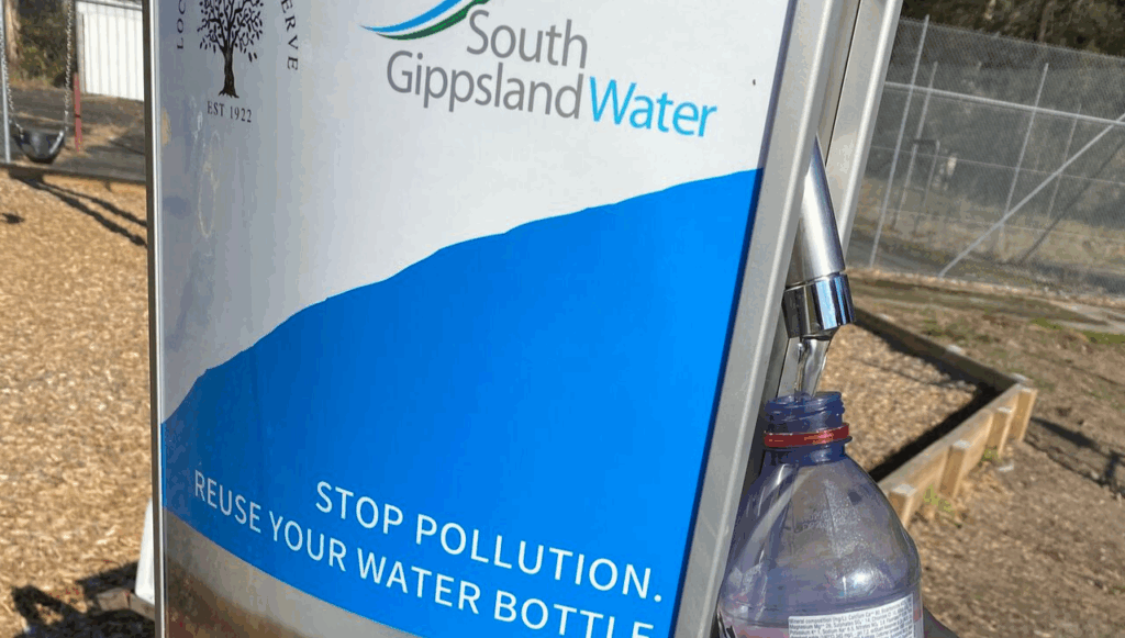 Water fountain filling a plastic bottle. Fountain enscribed with South Gippsland Water