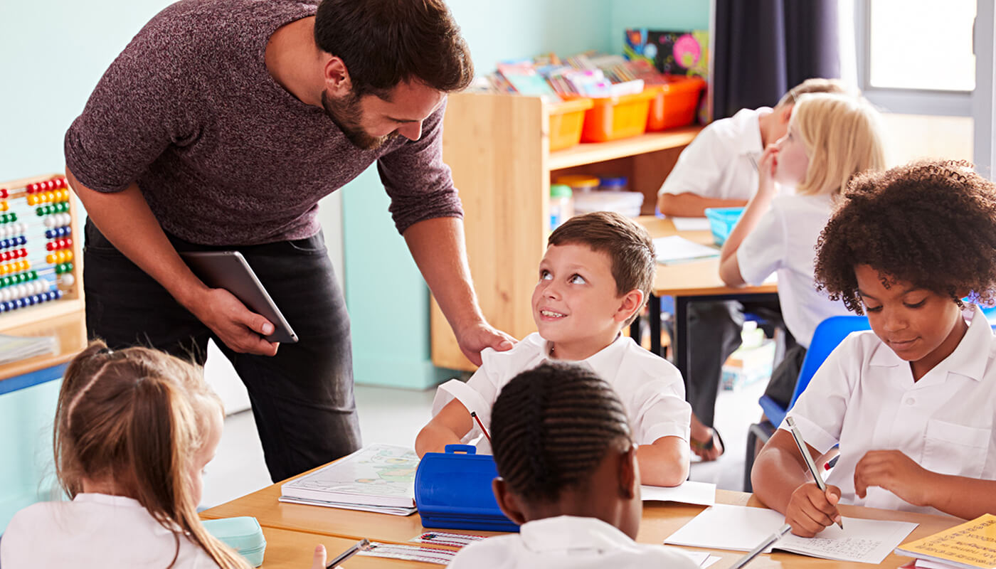 Teacher interacting with student in class