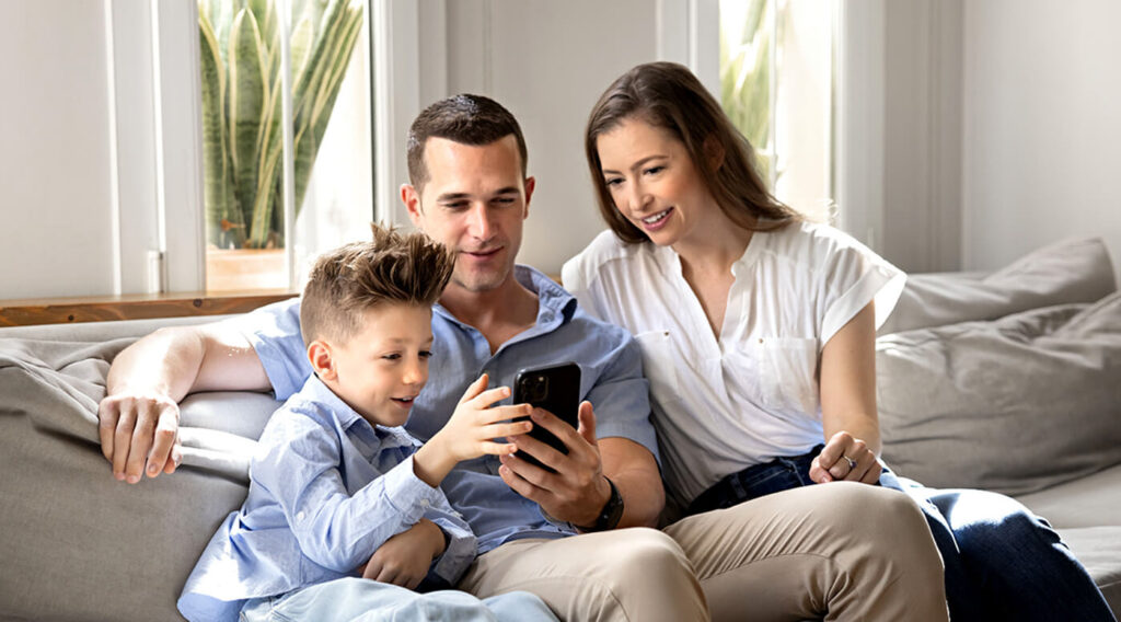 Family with young child on device