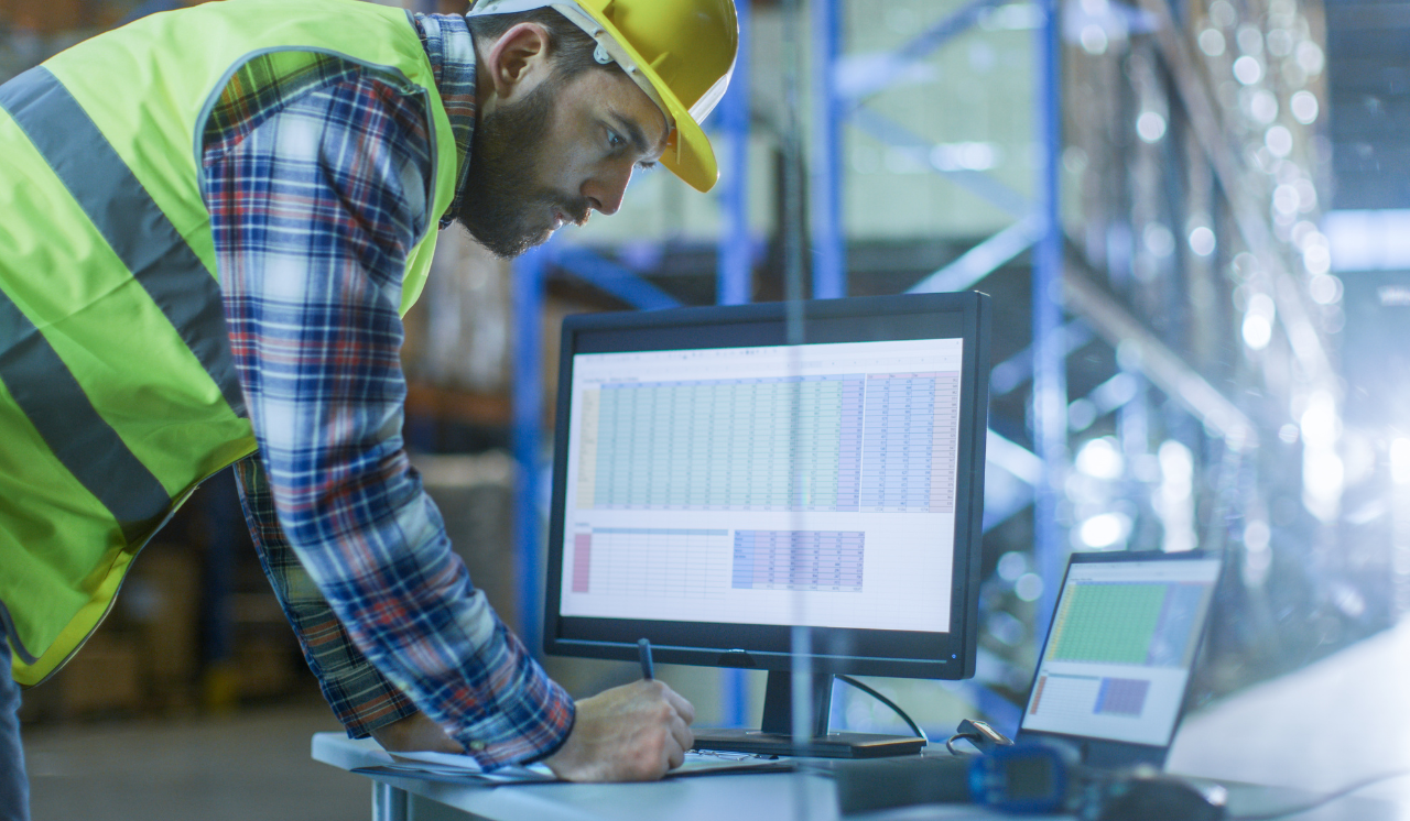 Person in warehouse in front of computer