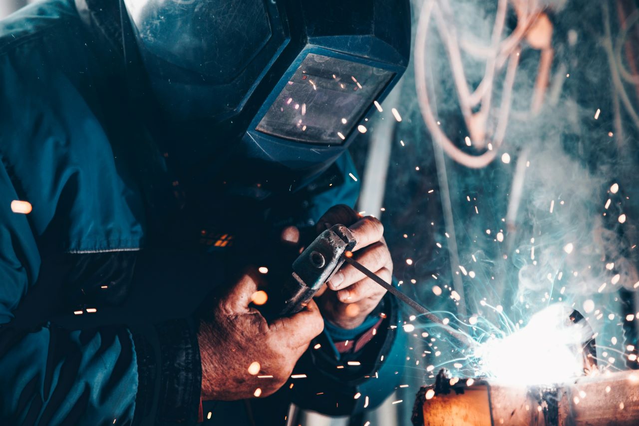 Man wearing safety gear welding metal