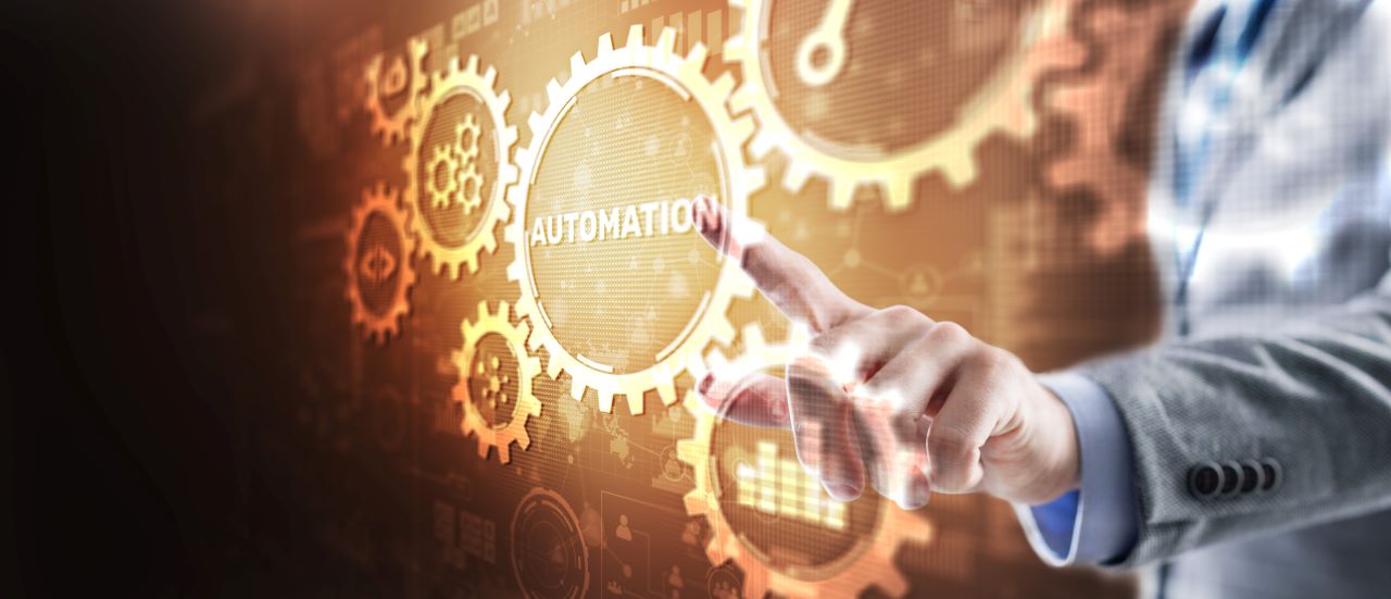 man pointing to automation cog.