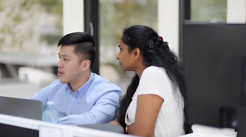 Two people looking at screen
