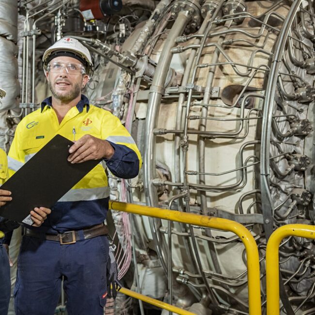 two mining workers checking machinery