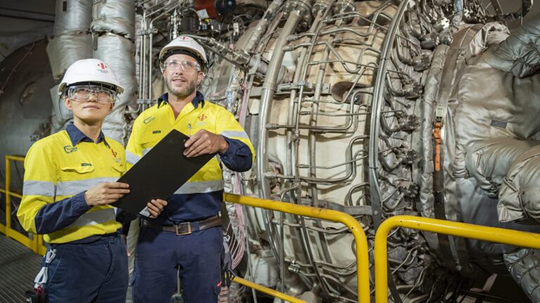 two mining workers checking machinery