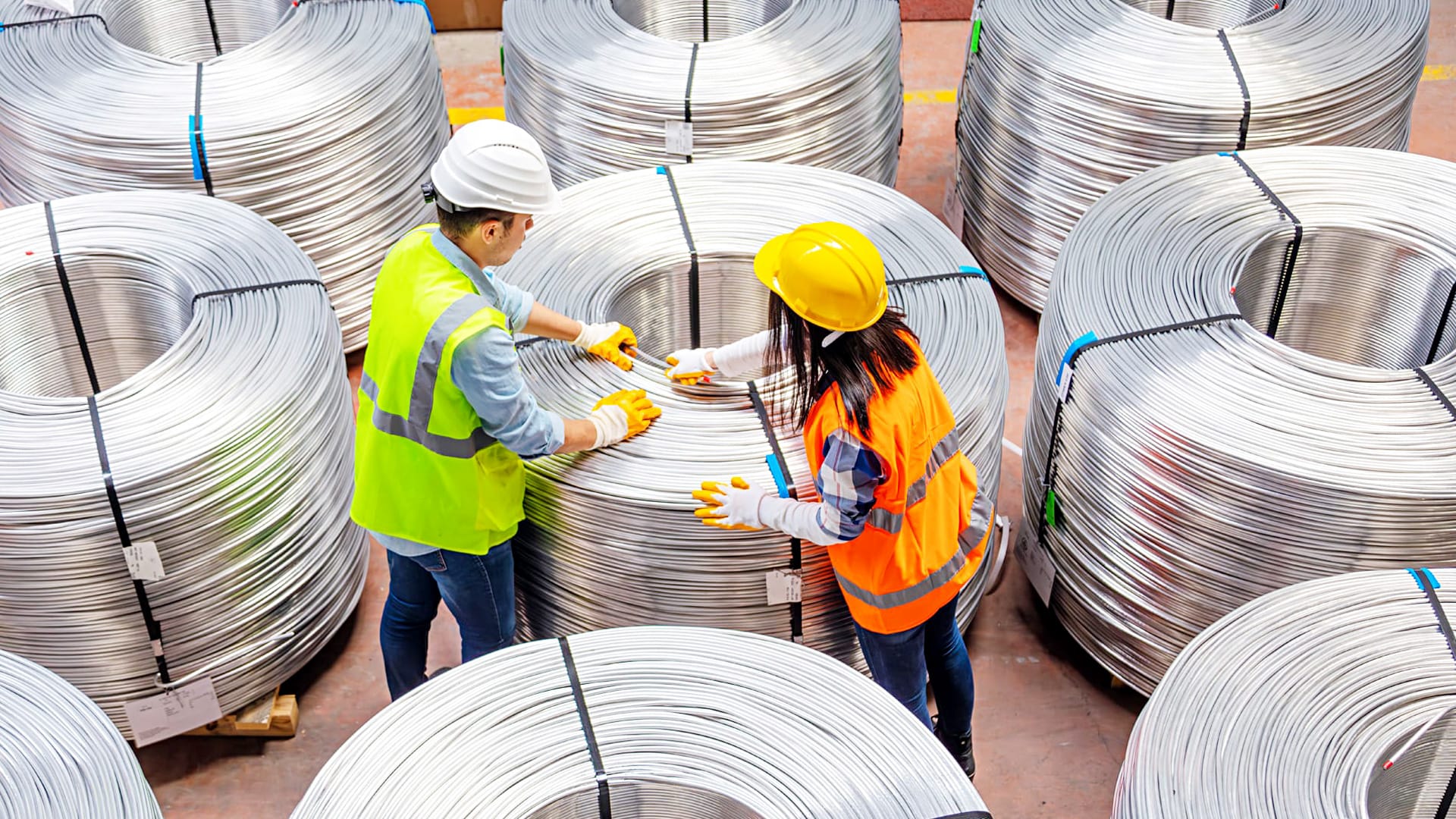 2 people inspecting wire bundles