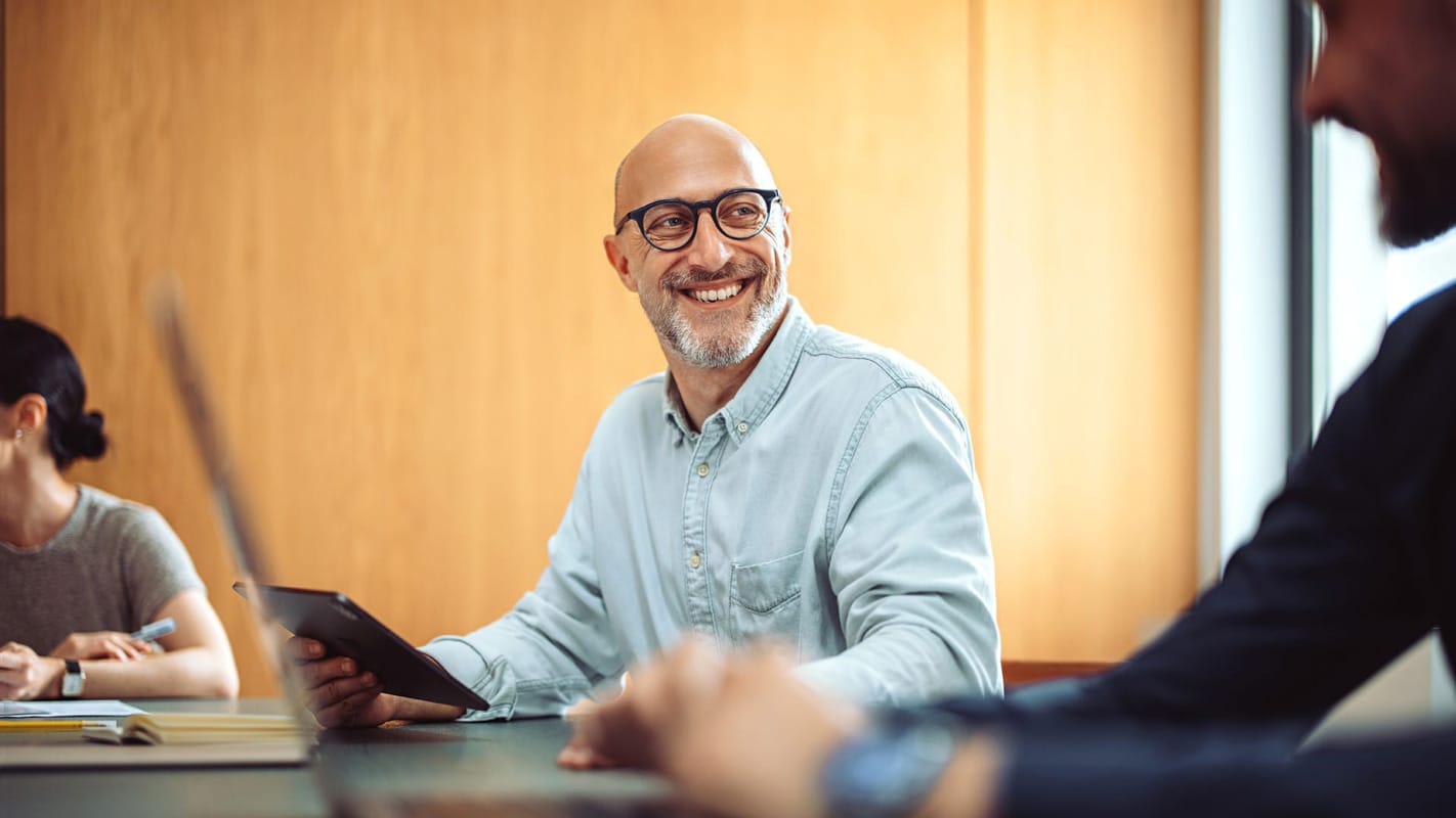 Person sitting in front of computer smiling